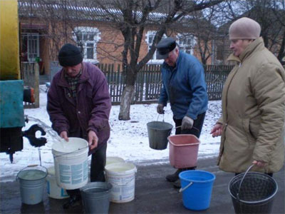 31 січня Іван Секалюк (у центрі) із сусідами набирають у відра й бідони чисту воду. Її привозять цистерною з місцевого водоканалу у центр Турбова Липовецького р-ну